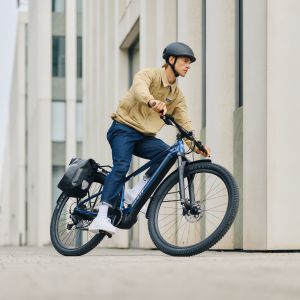 A city cyclist pedals through a turn on their Giant Talon E+ EX as they commute through the streets.