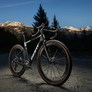 An angled view of the Giant Revolt Advanced SL 0 staged with snow capped mountains in the background.
