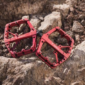 red flat pedals on rocks