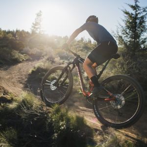 Mountain biker on a Giant Anthem Advanced rides through a flowy trail with Crest FloTrac XC shock.