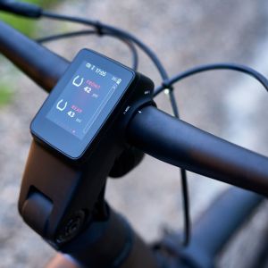 A close up look of the integrated computer dashboard of the Giant AnyTour X E+ adventure bike in the forest.