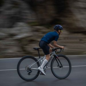 A youth road biker ascends out of the saddle on a Giant Seek with SLR 40 1 650b wheels.