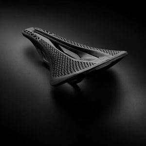 CADEX Amp 3D saddle with a stylized black background.