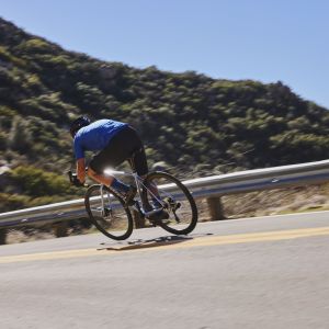 Cyclist descending mountain road on Giant TCR Advanced.