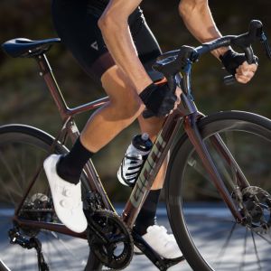 Cyclist riding out of the saddle on Giant SLR hanldebars.