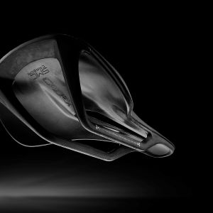 CADEX Amp 3D saddle with a stylized black background.