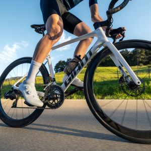A close up look at a cyclists Giant Surge road shoes as they ride by.