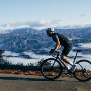 Roadie traverses mountain road on a Giant TCR Advanced Pro 0.