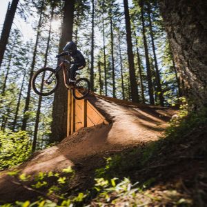 Young rider jumping on youth full suspension bike