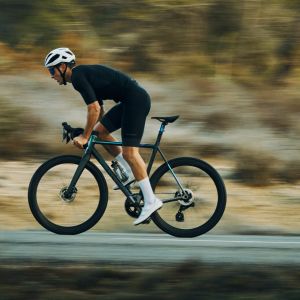 road cyclist sprinting out of saddle on a road bike