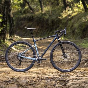 Revolt X gravel bicycle on dirt road in profile