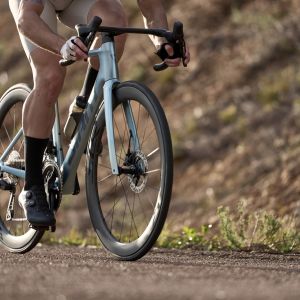 closeup of aero road bike being ridden on road
