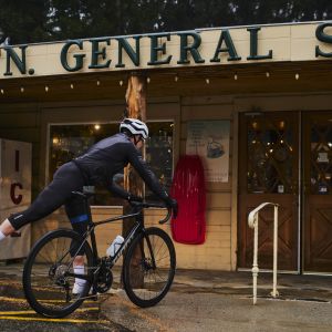 Cyclist gets off of Giant TCR Advanced Pro at Palomar Mt. General Store.