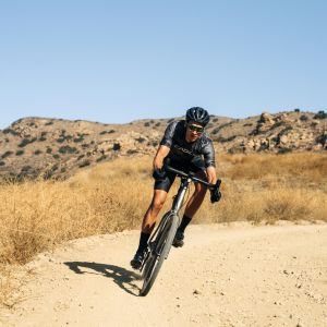 Gravel cyclist with CADEX GX Handlebar on bike riding on fire road