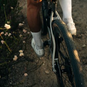 An overhead look at a gravel bike with CADEX GXR tires on a dirt road.