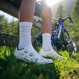 A cyclist sits by the side of the road wearing a pair of Giant Surge Pro Road bike shoes.