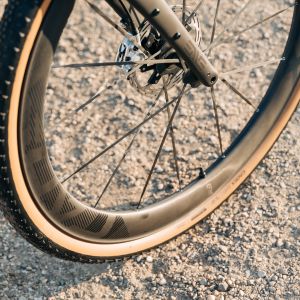 A close up look at the front wheel from the gravel specific CADEX Max GXR wheelsystem out on a trail.