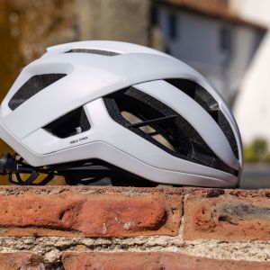 A close look at the side of the Giant Rev Pro helmet on a brick wall.