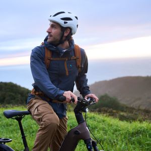 An adventure cyclist takes a pause to look back at the road behind him astride their Giant AnyTour X E+.