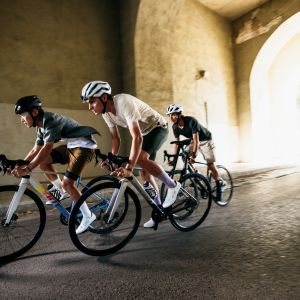 A group of cyclists riding through the streets on Giant Contend SL road bikes.
