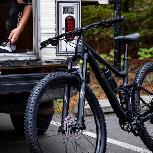 the new Embolden mountain bike propped against a van while a rider gets ready inside