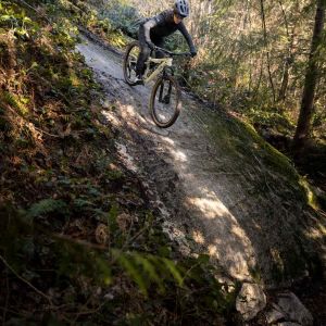 Woman riding Liv Embolden down super steep rock face.