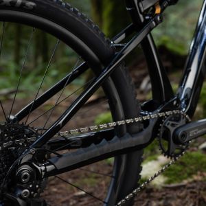 A close up look at the rear mechanism and triangle of the Giant Stance full suspension trail bike in the woods.