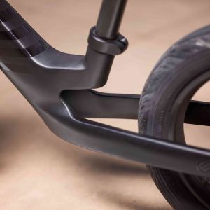 Close up view of Pre rCarbon strider bike rear wheel and seat post.