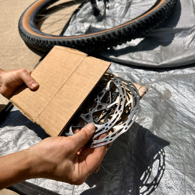 Remove the brake rotors from your wheels and place between two pieces of cardboard.