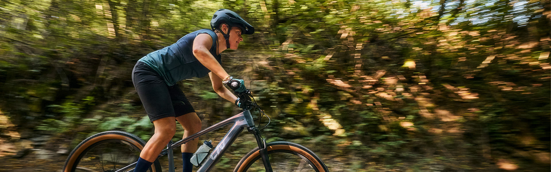 image of a man riding a Giant mountain bike with mountains in the background