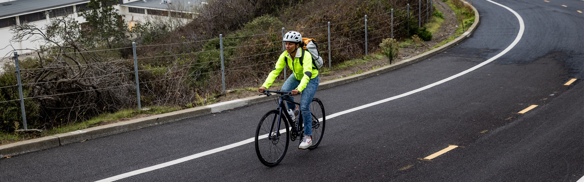 image of a woman commuting on her bike wearing high-vis clothing