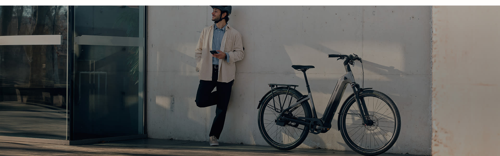city e-biker leaning against awall