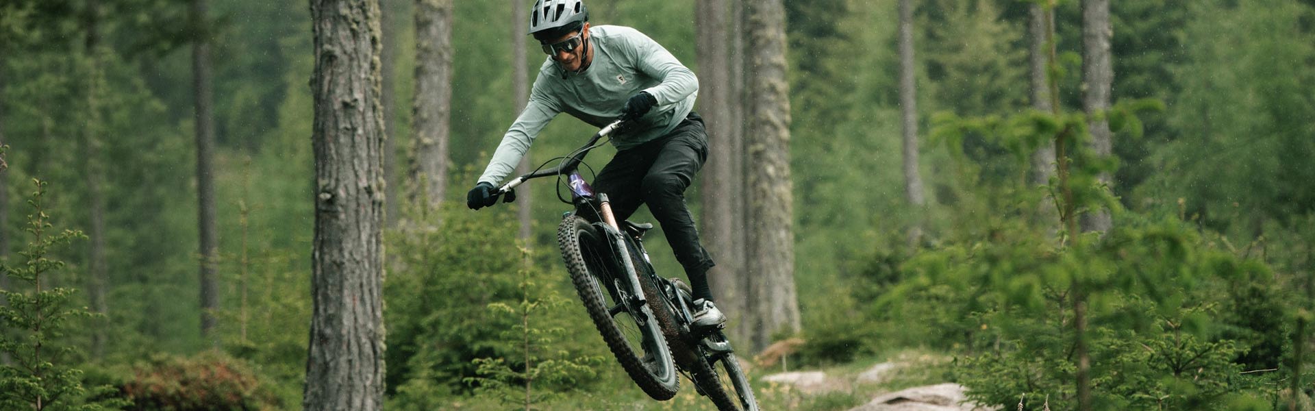 rider jumping e-bike on a trail.