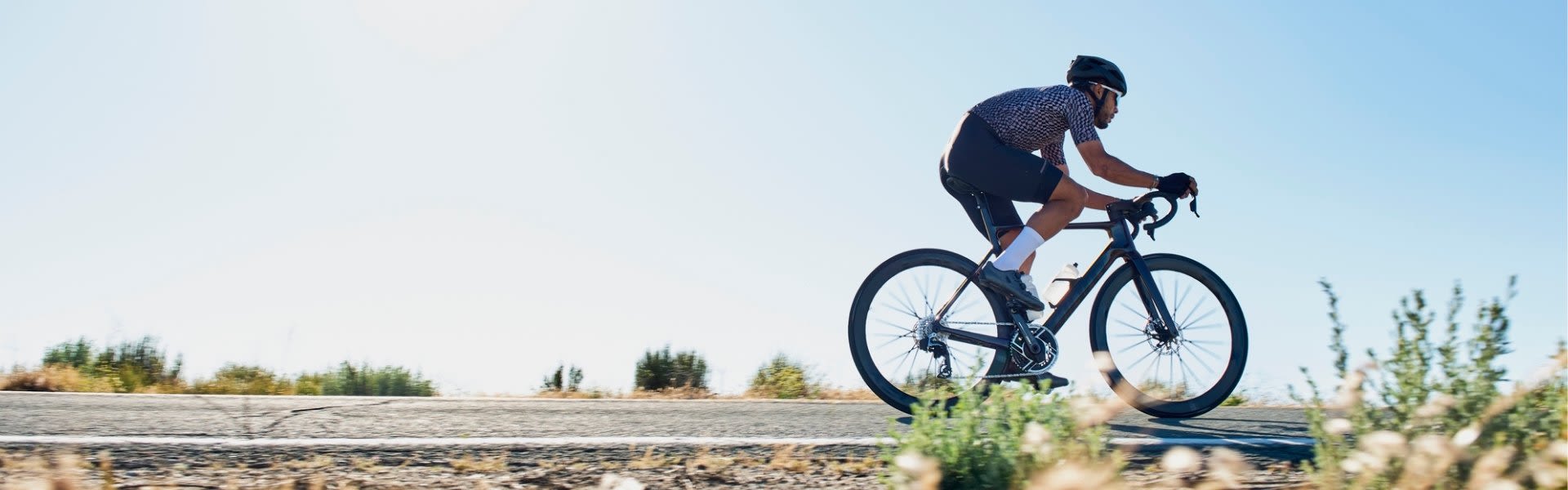 Man riding a Giant bike on flat road