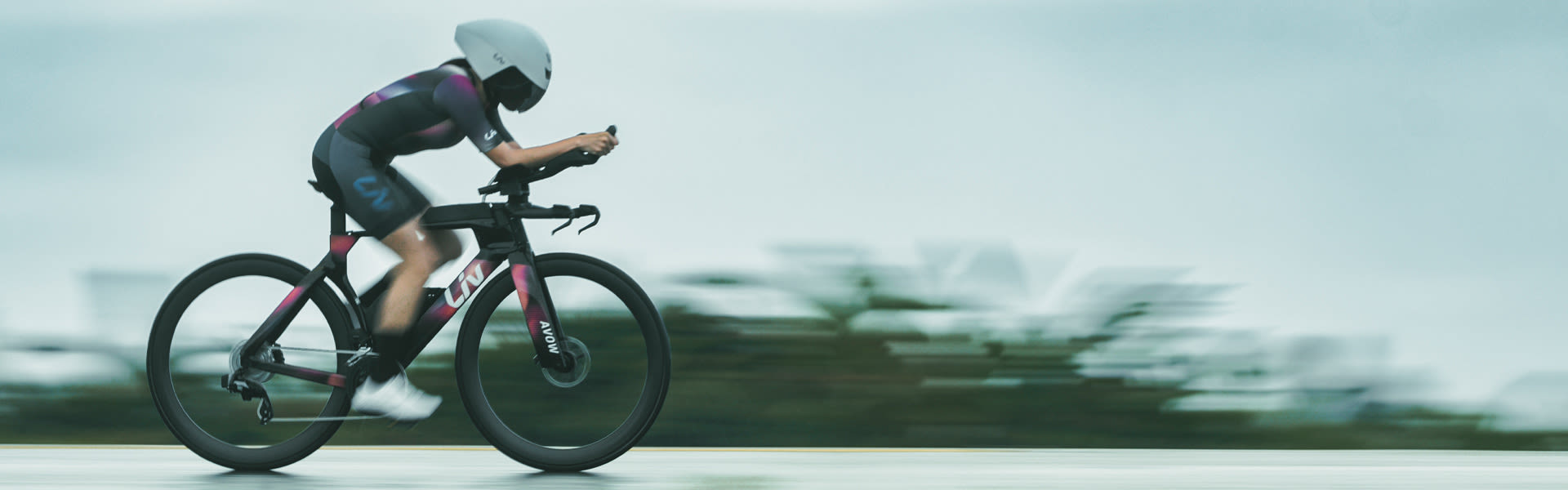 a woman riding a triathlon bike