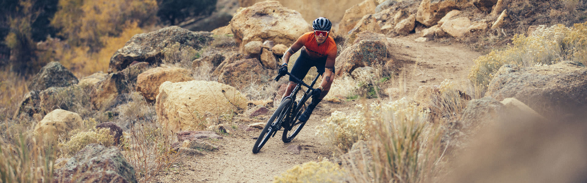 image of a man riding the giant revolt gravel bike on a dirt path