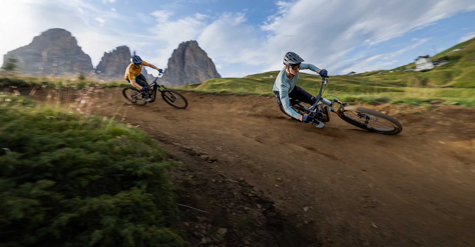 mountain bikers riding e-mtbs in dolomites