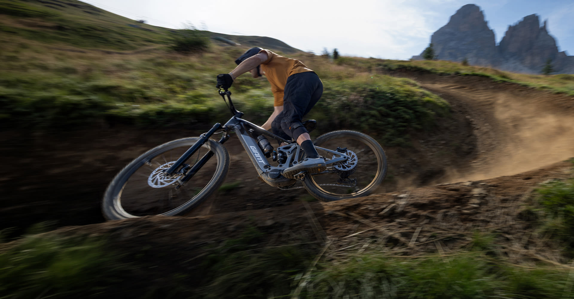 e-bike rider turning a dirt corner.