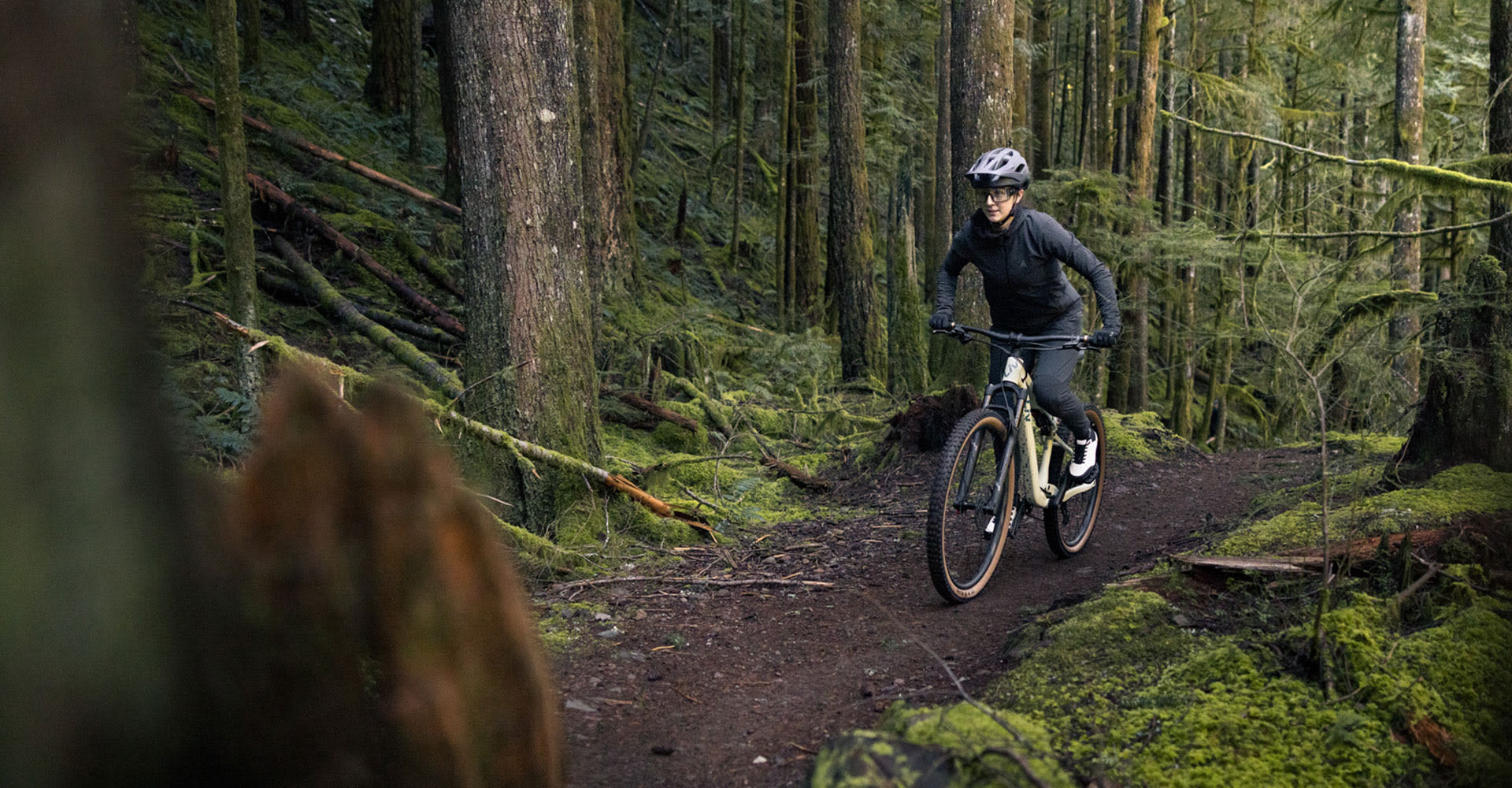 Woman riding Liv Embolden in the mountains.