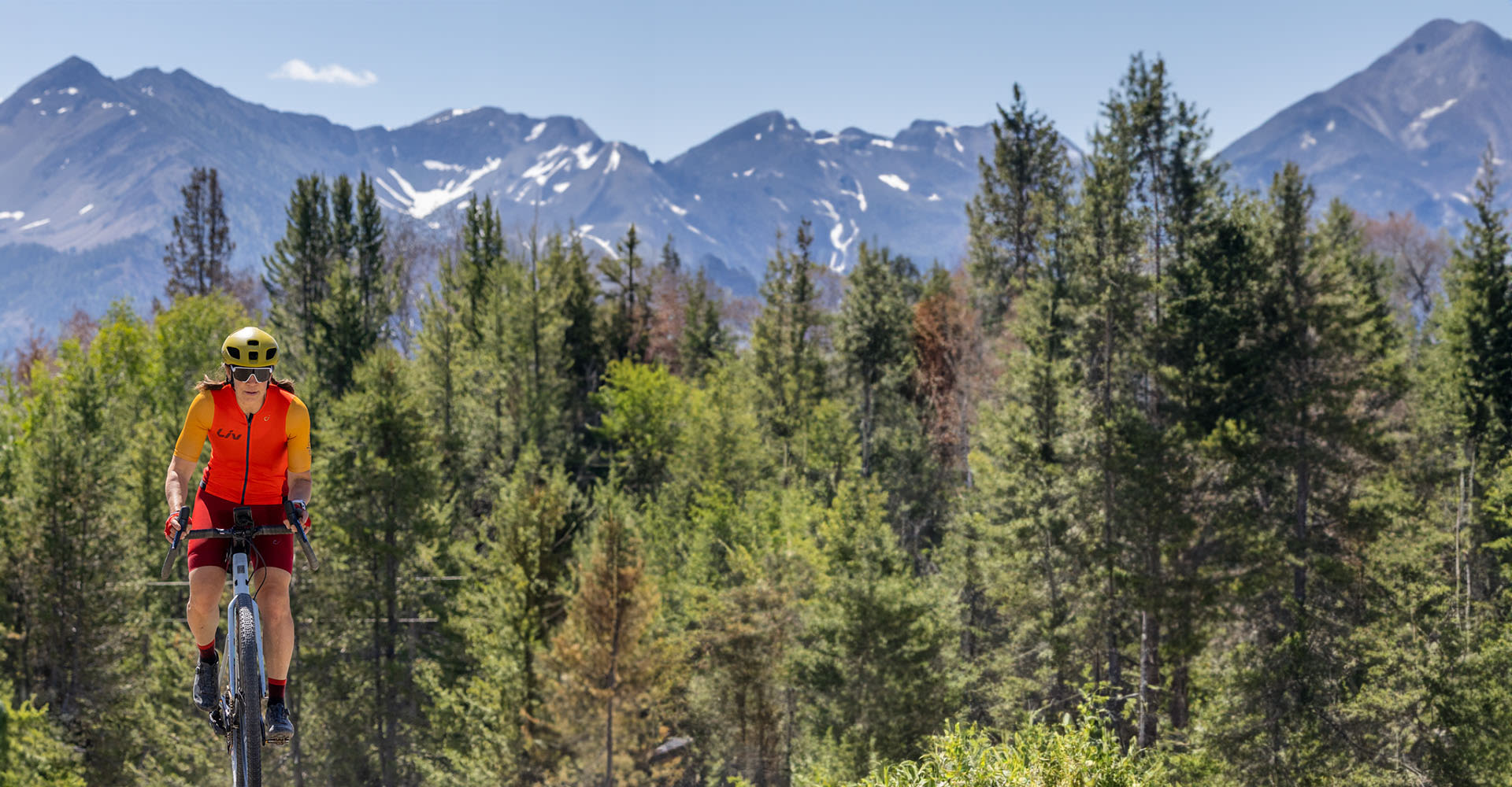 Rebecca charging forward on her bicycle.
