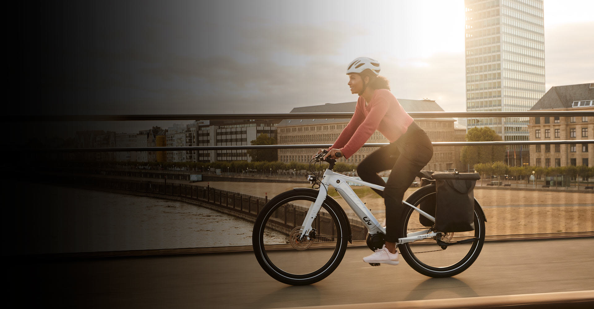 a woman riding an e-bike in a city