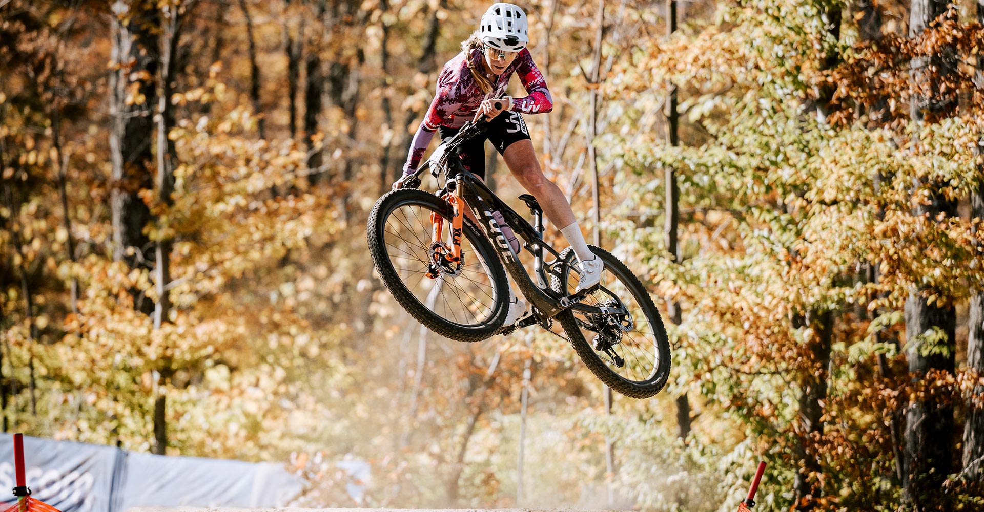 woman mountain bike racer jumping tabletop