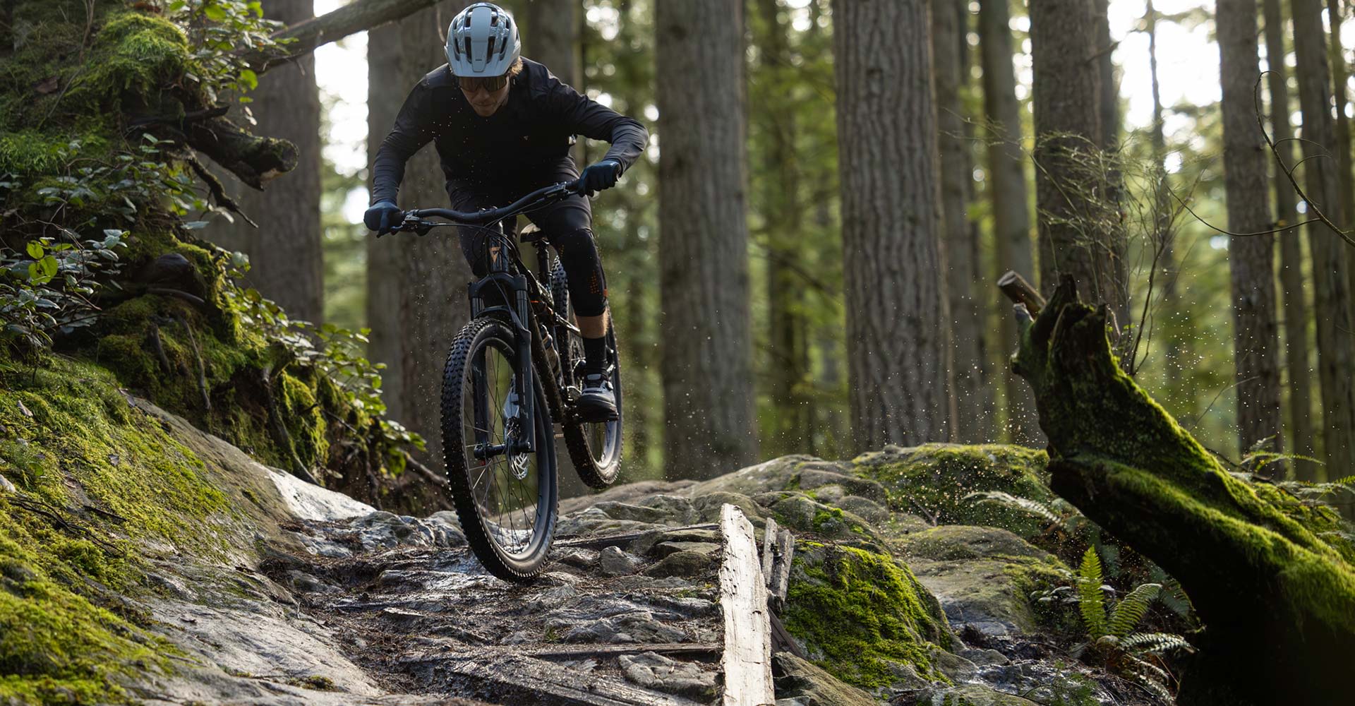 mountain biker riding stance up technical trail