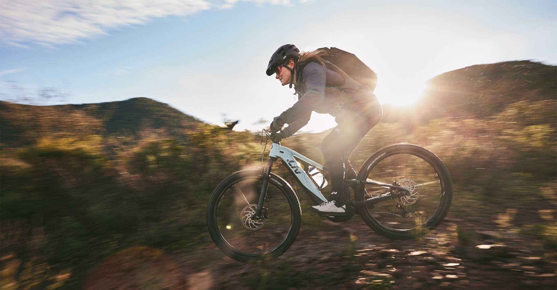 Woman riding dirt trail