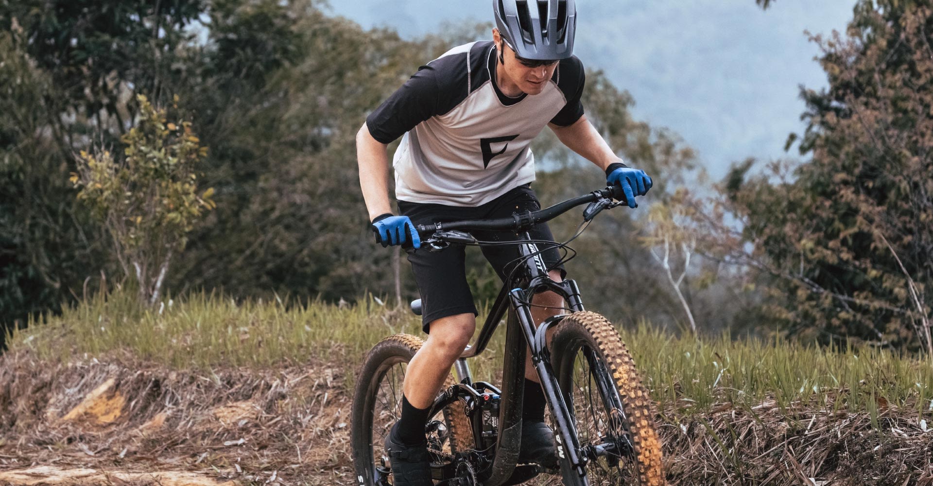 Mountain biker out of saddle and riding a bike
