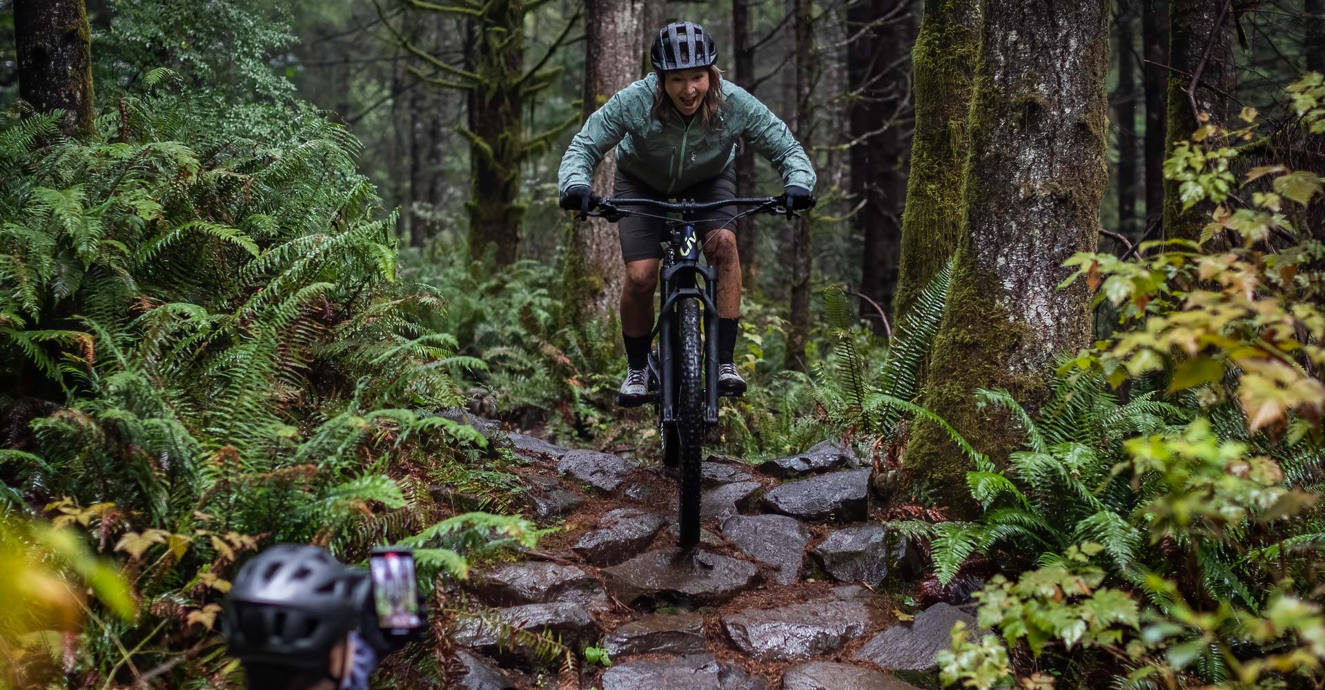 a woman riding the new Embolden down a rocky trail