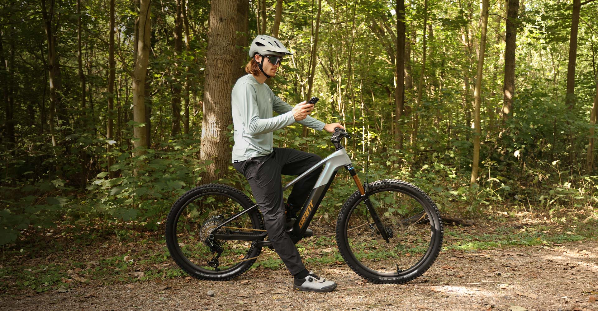 Person using RideControl App while sitting on an e-bike.