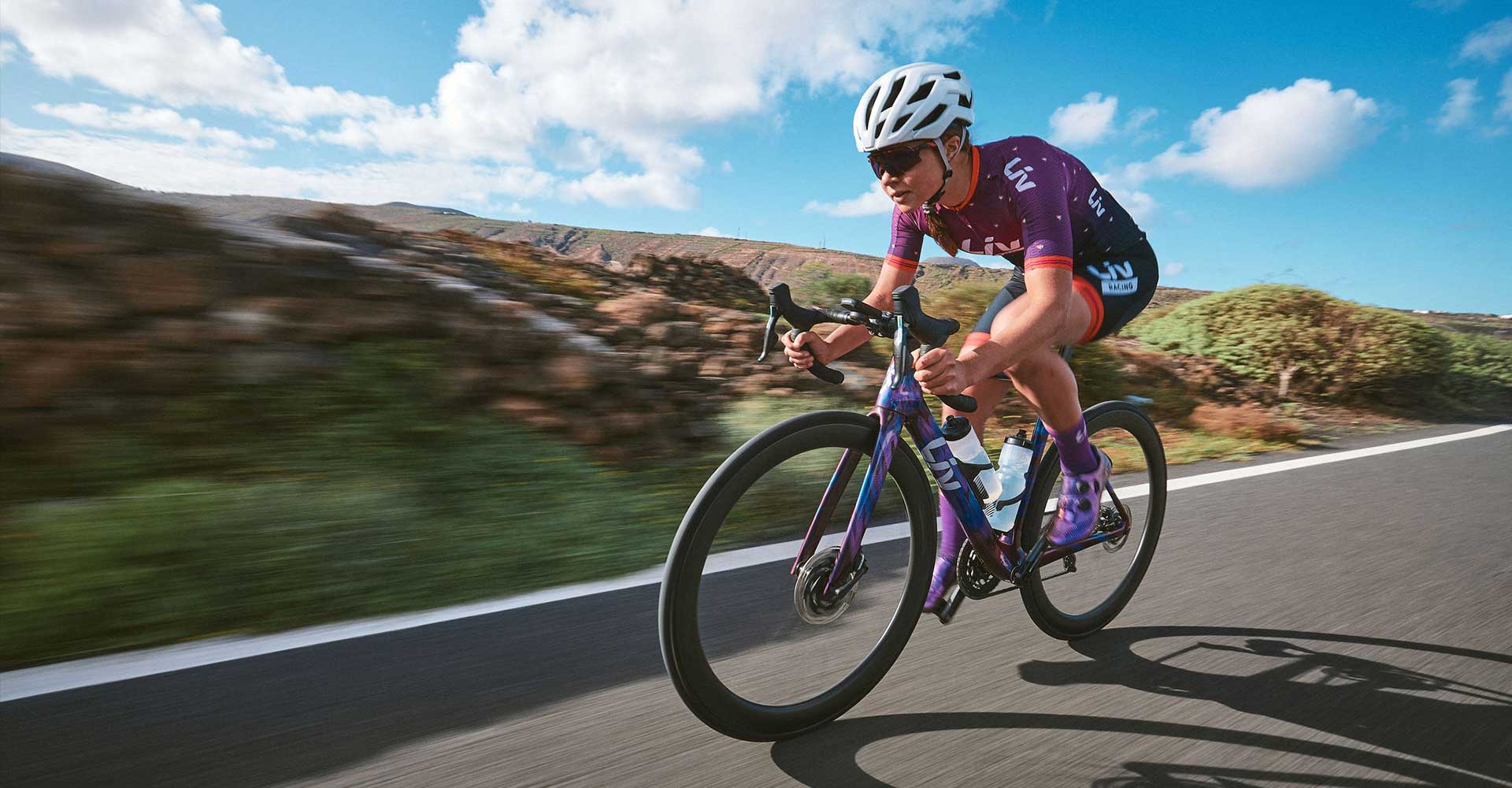 Lisa riding down a road fast