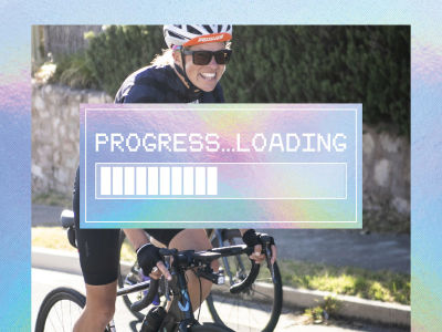 Female cyclist smiling and riding along the road