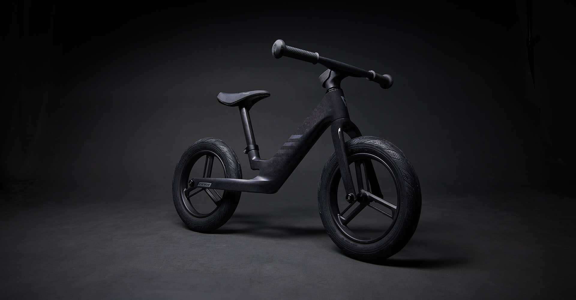 balance bike on black background